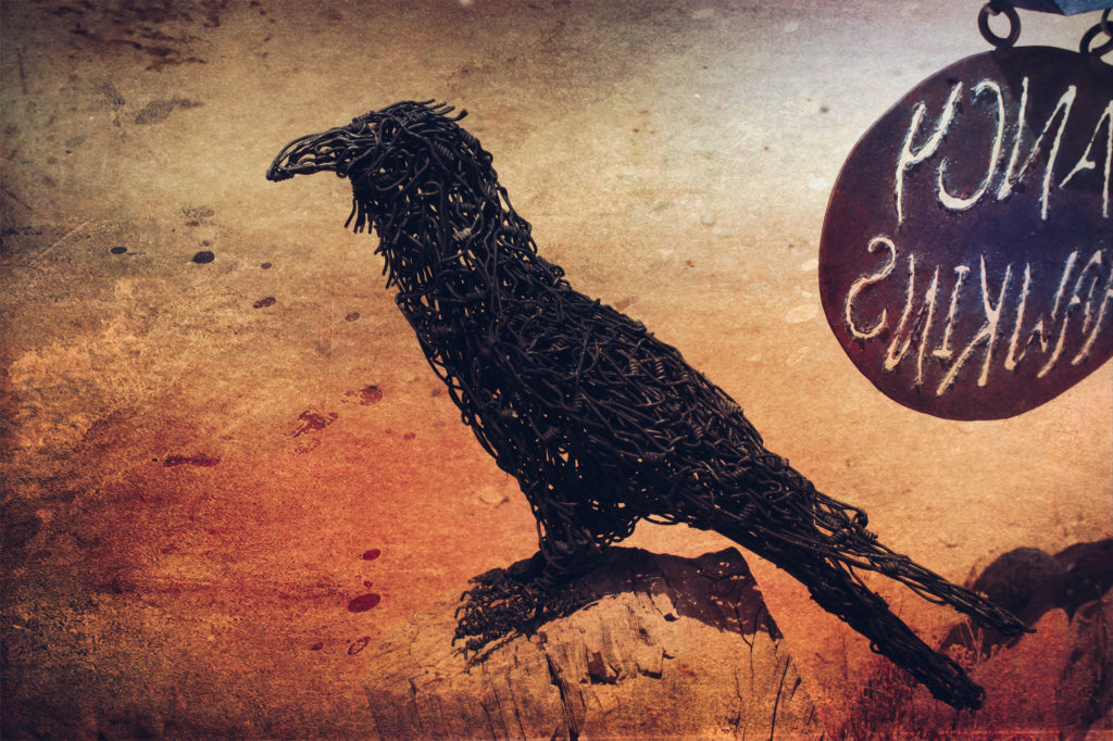 Handmade raven statue in the Land of the Dead Cemetery in Madrid, New Mexico.