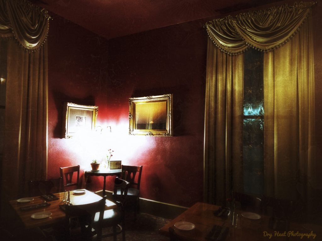 Red and gold dining room in the Luna Mansion.