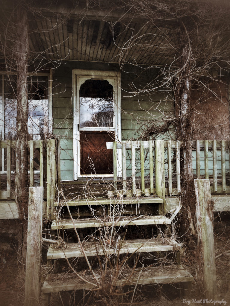 Front porch of an abandoned house in Libertytown, Maryland.