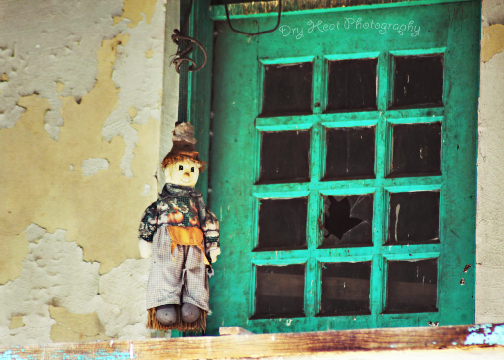 A doll hangs in an upstairs window of the abandoned Kuhn Hotel in Belen, New Mexico.