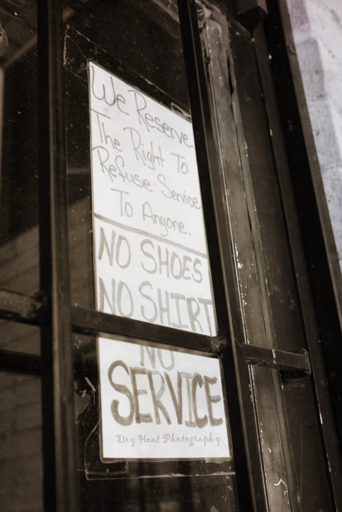 Sign on the door of the abandoned Doll Gas Station in Belen, New Mexico.