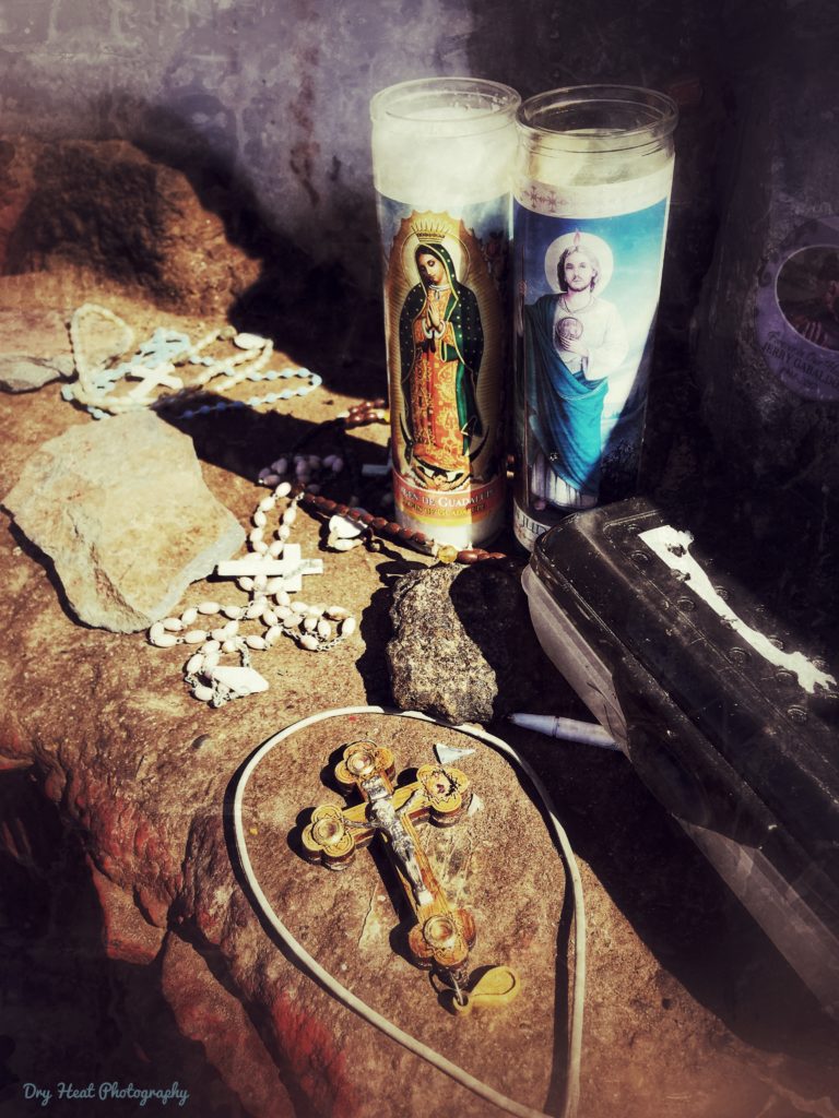 Candles and rosaries left behind as offerings at the top of Tome Hill in Tome, New Mexico.