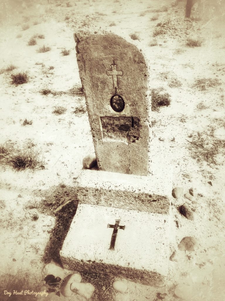 A concrete grave marker at Our Lady of Guadalupe Cemetery in Peralta, New Mexico.