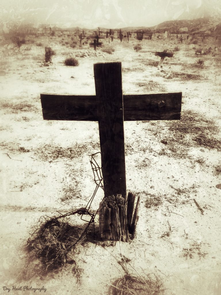 Wooden cross grave marker at Our Lady of Guadalupe Cemetery in Peralta, New Mexico.
