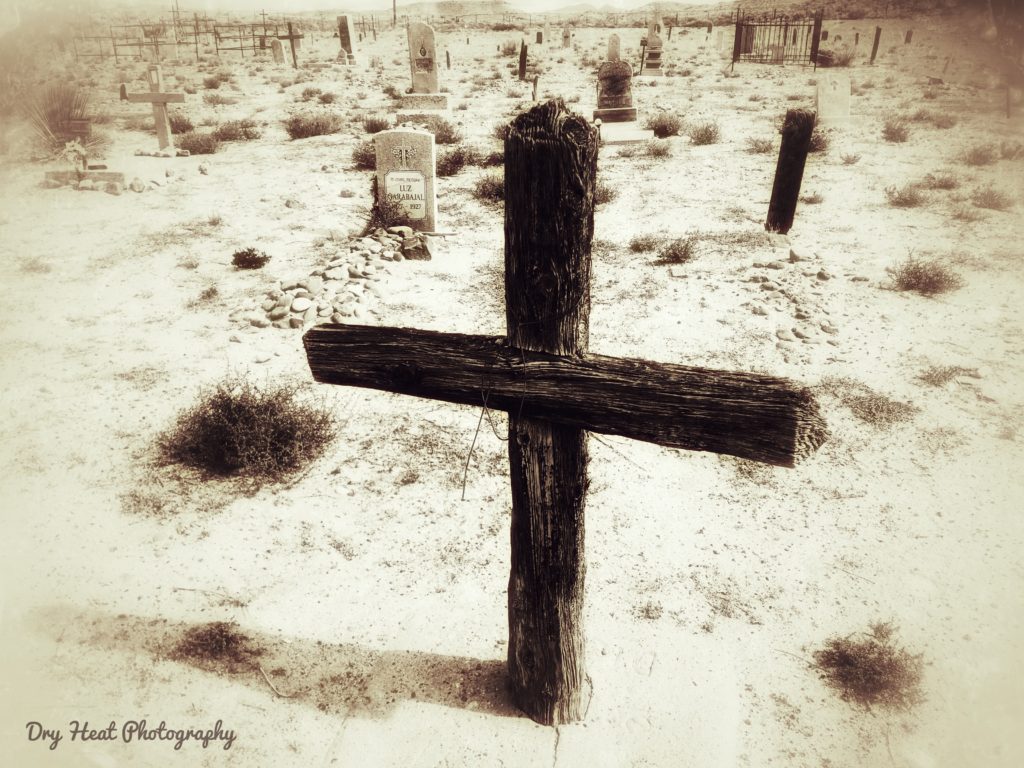 Wooden cross grave marker at Our Lady of Guadalupe Cemetery in Peralta, New Mexico.