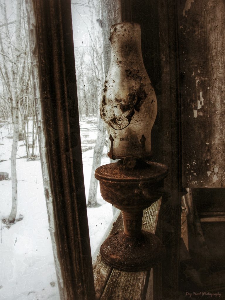 An oil lamp still sits in the window of this abandoned house in Navarino, Wisconsin.