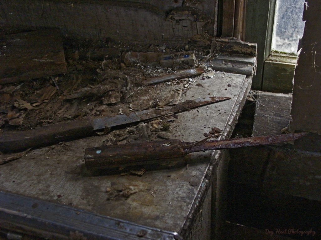 Rusted knives sit on the kitchen counter of this abandoned house in Navarino, Wisconsin.